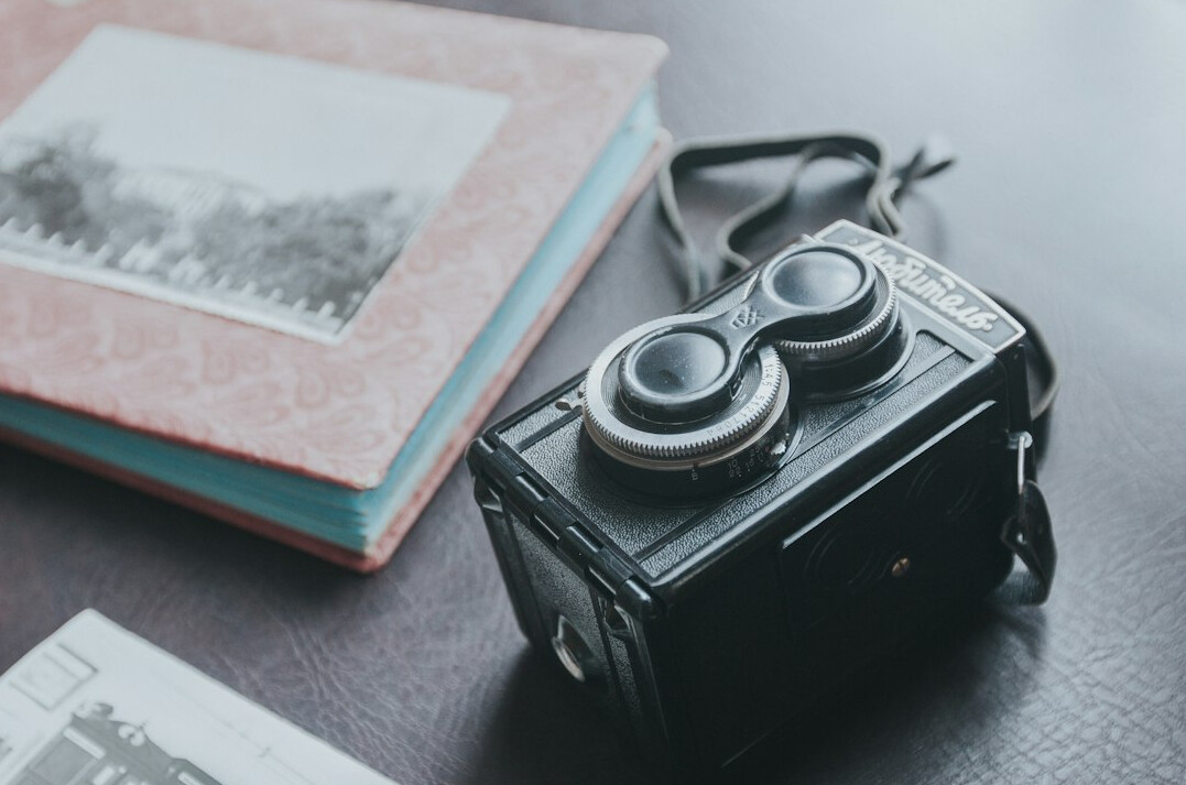 Travel planning with map camera and notebook on a table