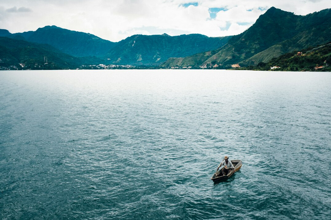 Scenic mountain lake with a small boat